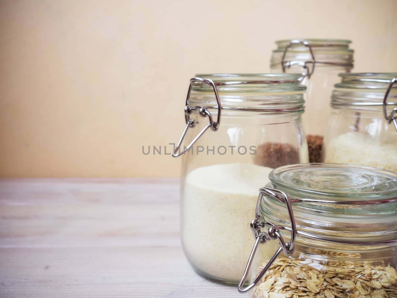 Cereals and grains in glass jars standing on the table