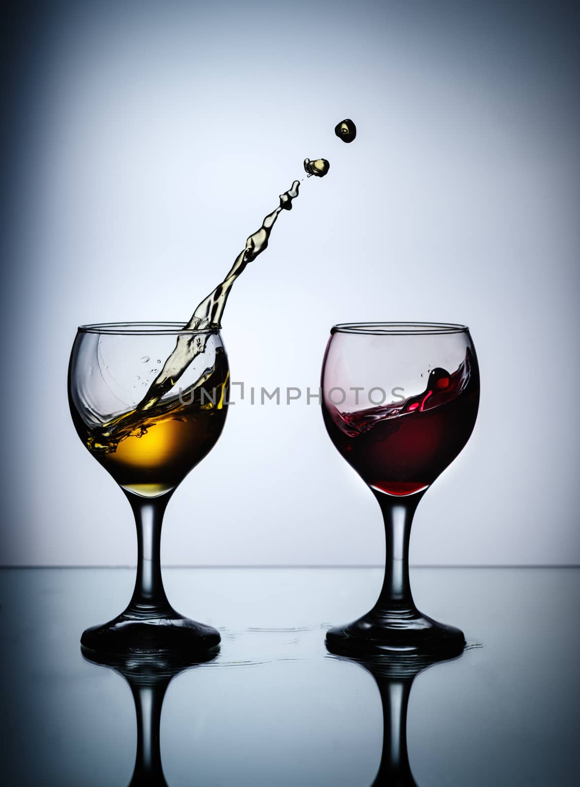 stream of wine being pouring into a glass closeup by dmitry_derenyuk