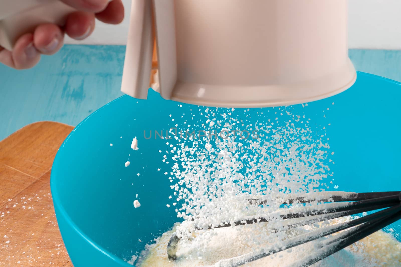 Sifting flour in the preparation of the dough - photo, image by galsand