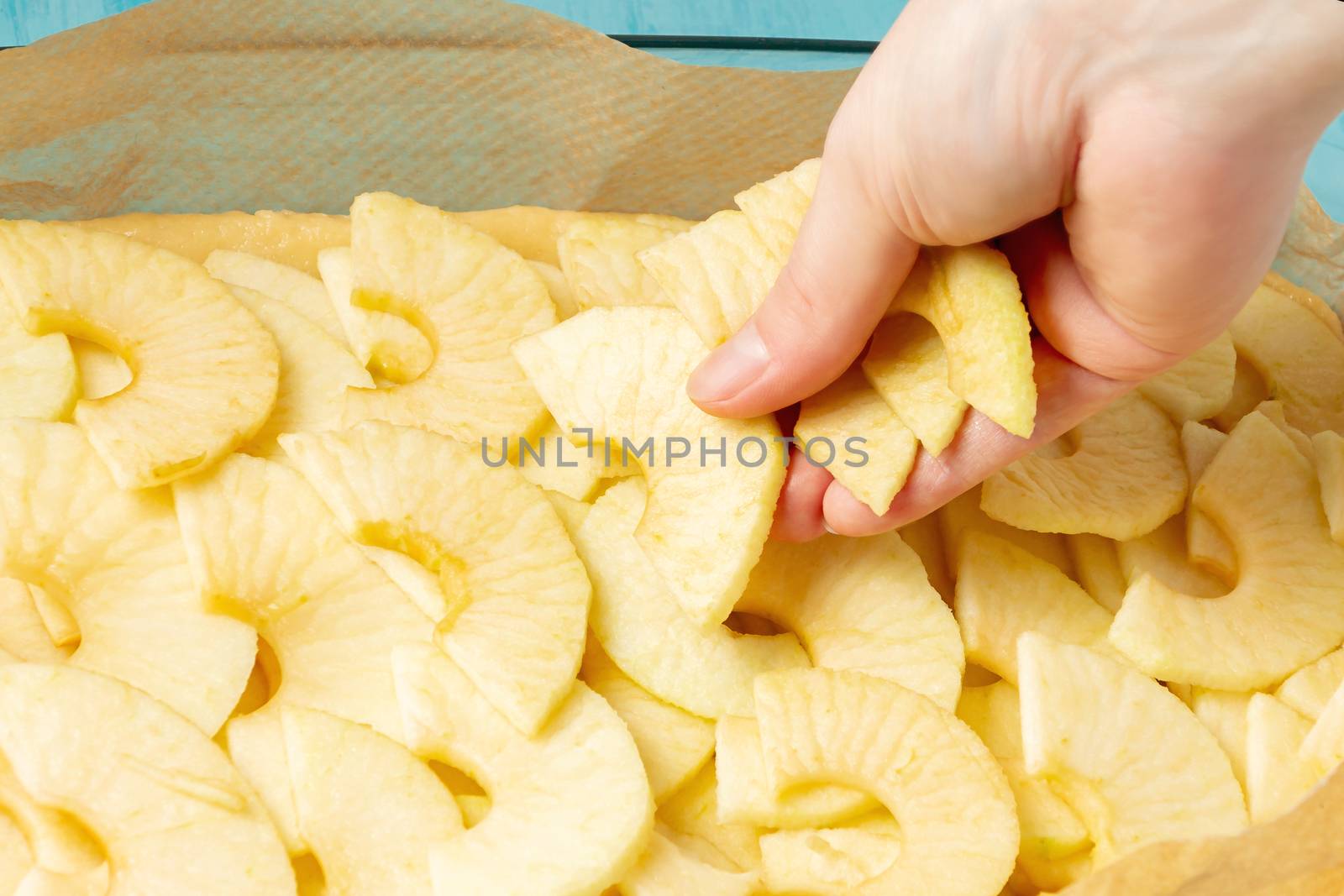 Putting apples on the dough in a baking dish. Cooking Apple Pie - photo, image.