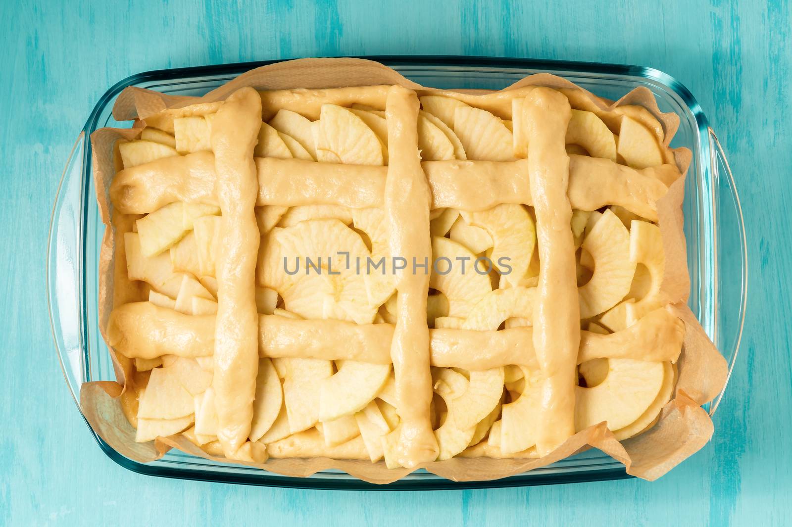 Unfolded apples on the dough in a baking dish. Cooking Apple Pie - photo, image by galsand