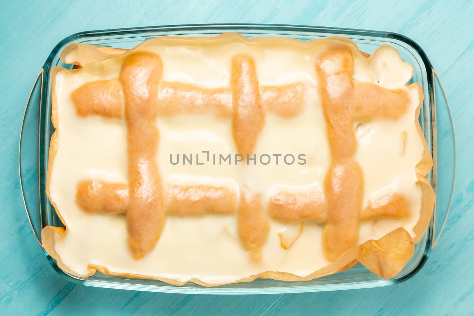 Freshly made homemade apple pie with cream of sour cream and sugar in a rectangular baking pan - photo, image.