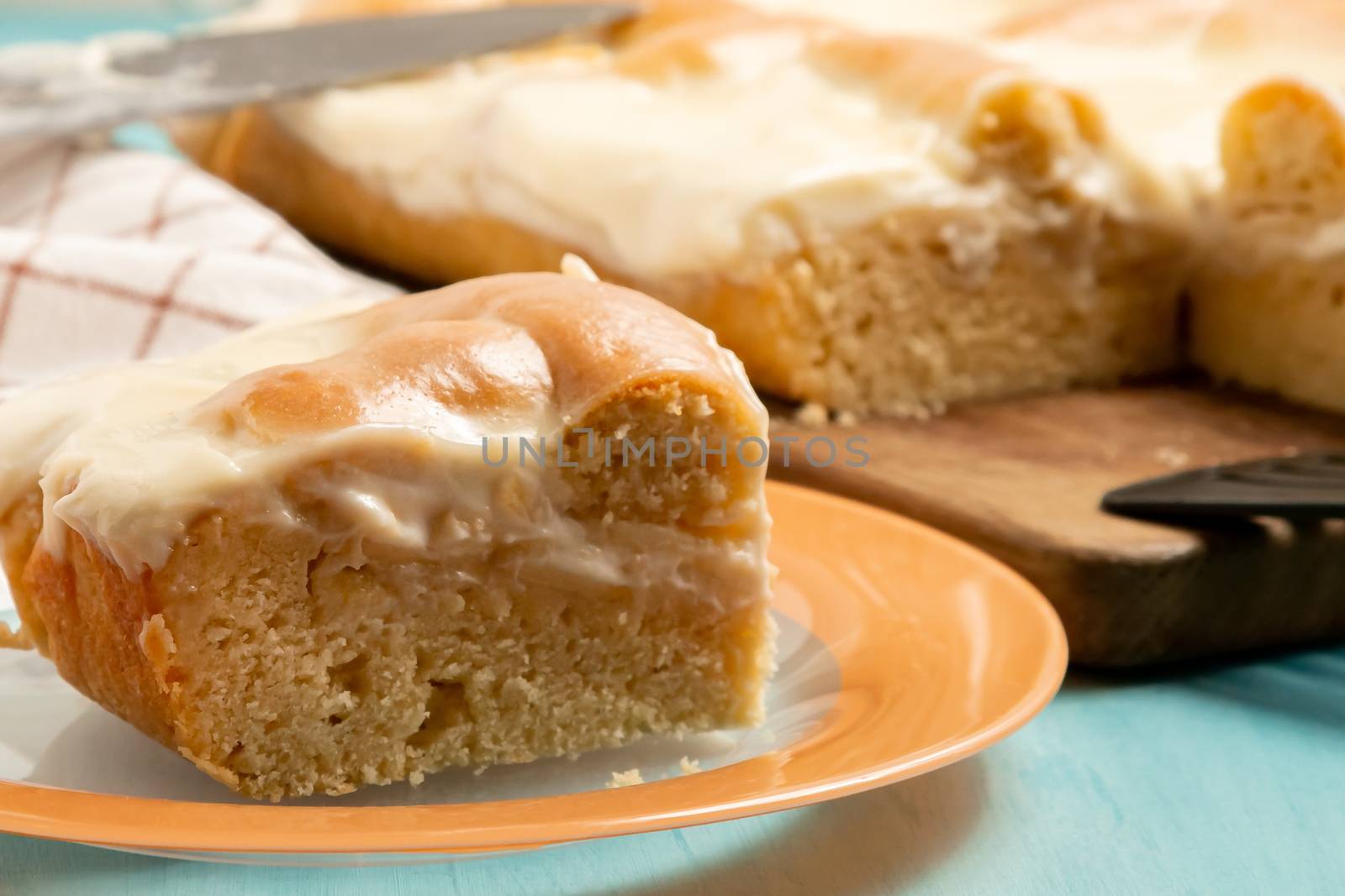 Sliced piece of apple pie with sour cream on a plate - photo, image.