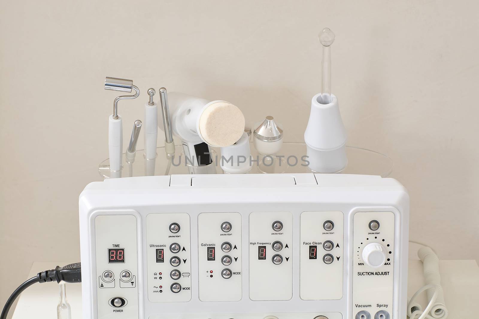 Cosmetic Multifunctional Device close-up in beauty salon. Ultrasound medical device. Darsonval device. Ultrasound procedure. Medical equipment healthcare. Young skin. Face professional massage.