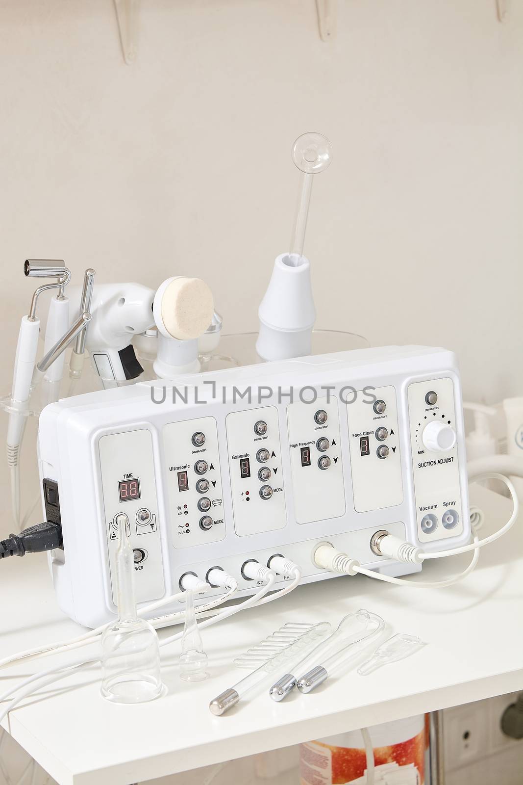 Cosmetic Multifunctional Device close-up in beauty salon. Ultrasound medical device. Darsonval device. Ultrasound procedure. Medical equipment healthcare. Young skin. Face professional massage.