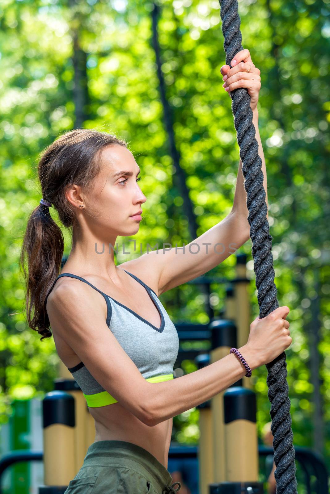 portrait of a woman with a rope on the playground, shooting during training