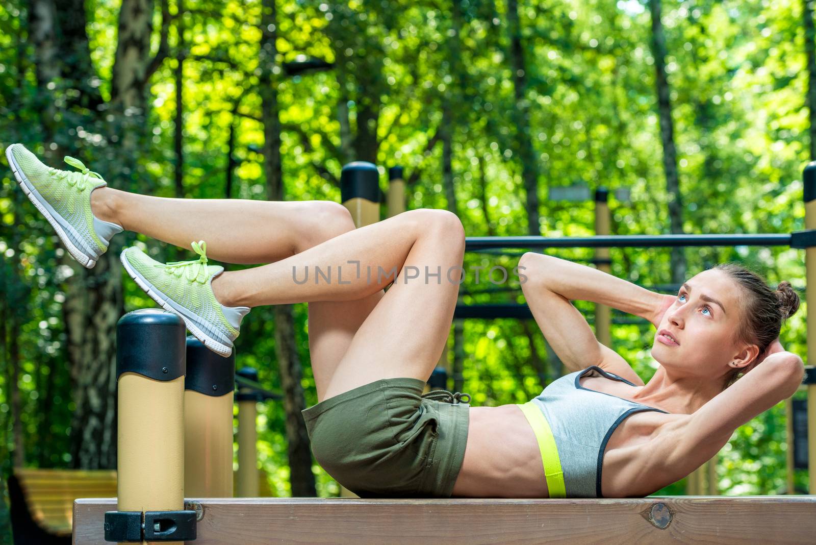 strong woman in sportswear goes in for sports outdoors in the park