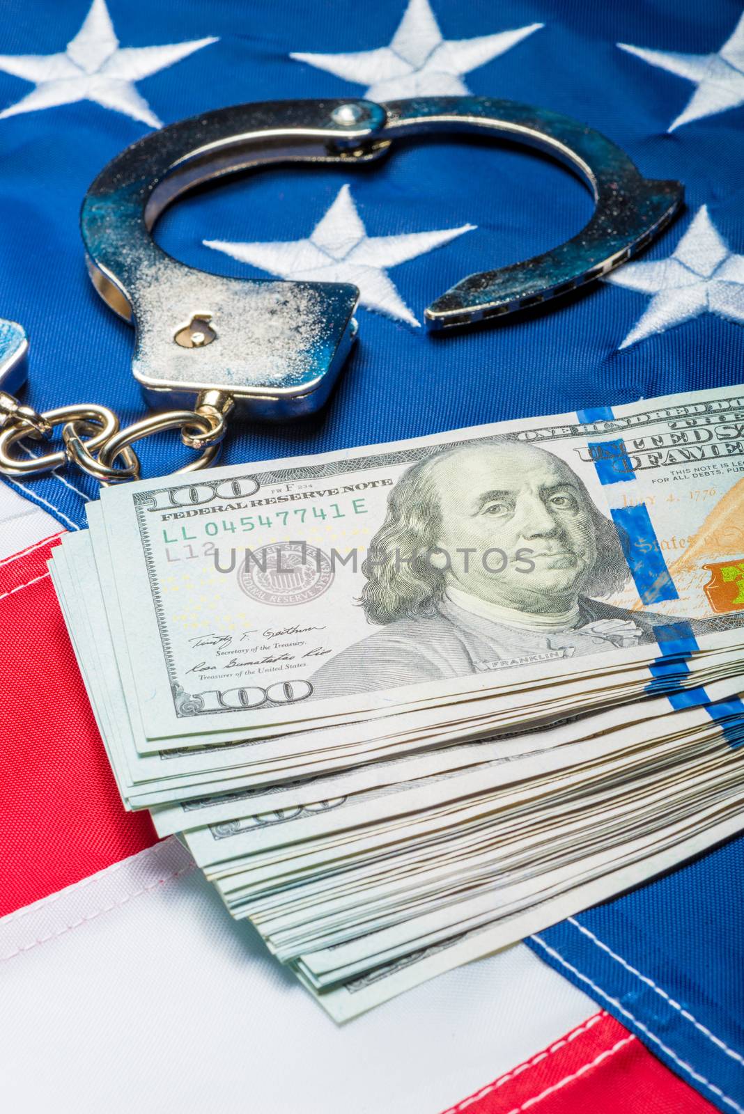 heap of money and handcuffs on american flag close up concept ph by kosmsos111