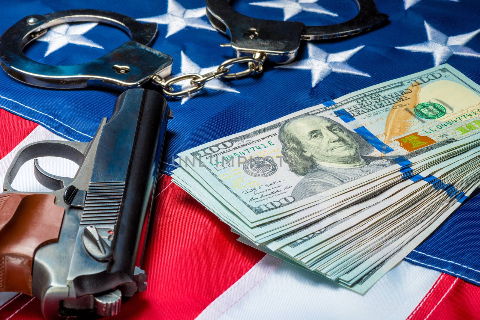concept photo of seized money and weapons on the American flag - by kosmsos111