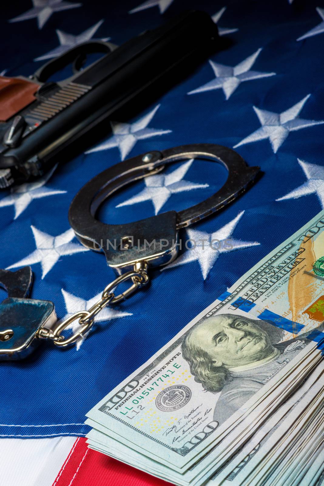concept photo crime and punishment withdrawn money and weapons on the American flag