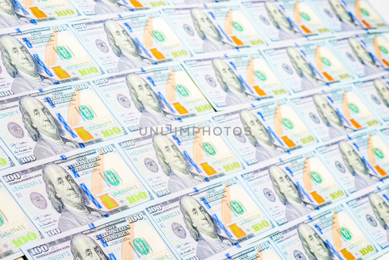 macro shot of 100 dollar bills in a row background