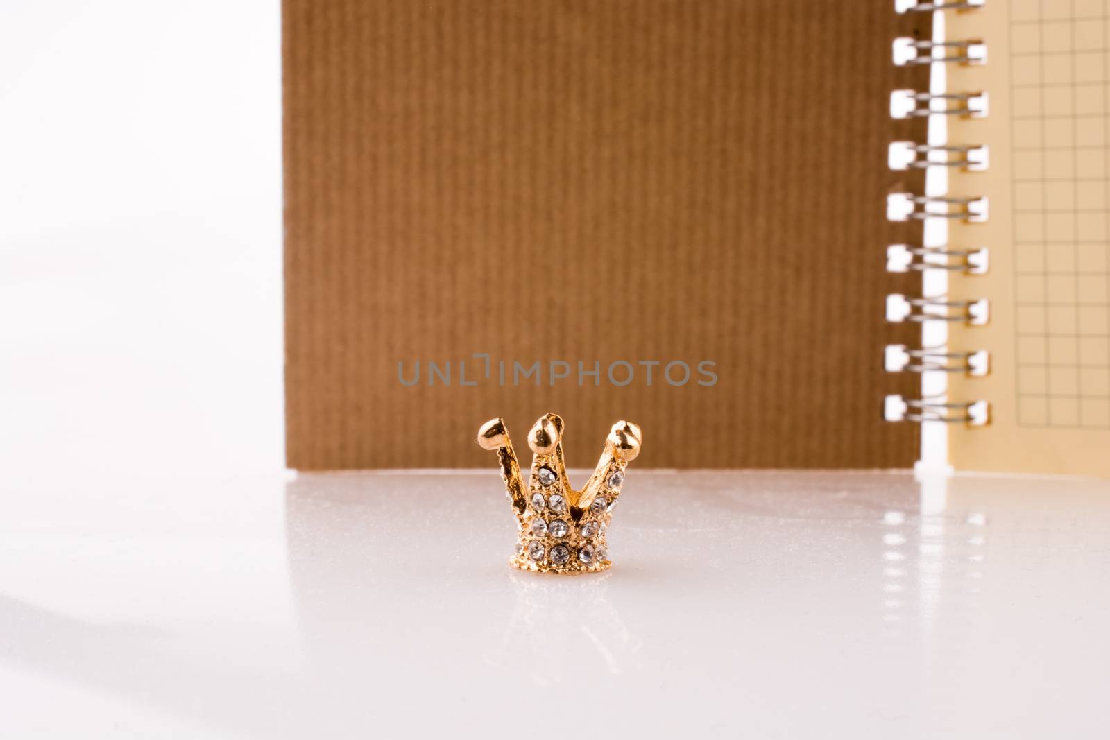 Crown with a notebook on a white background
