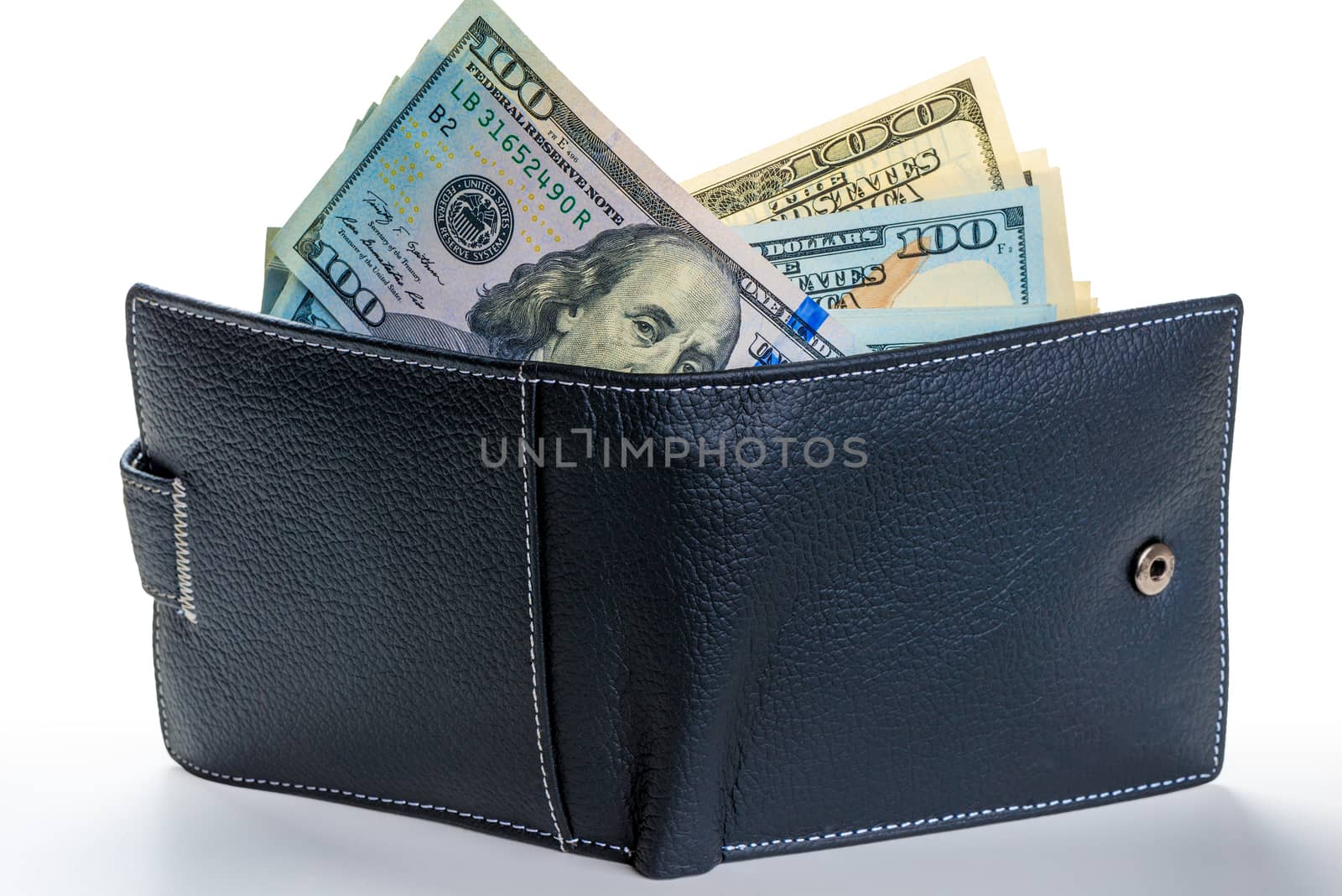 American dollars sticking out of a leather wallet full of money