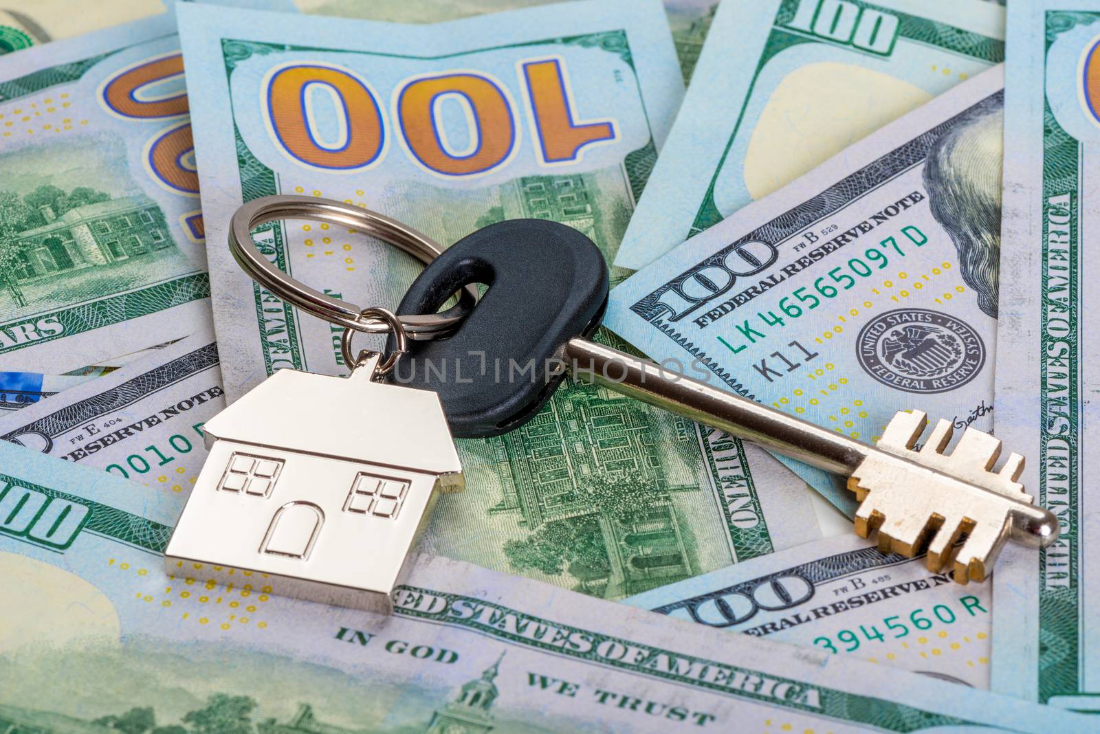concept photo of money and real estate a key from a new house on by kosmsos111
