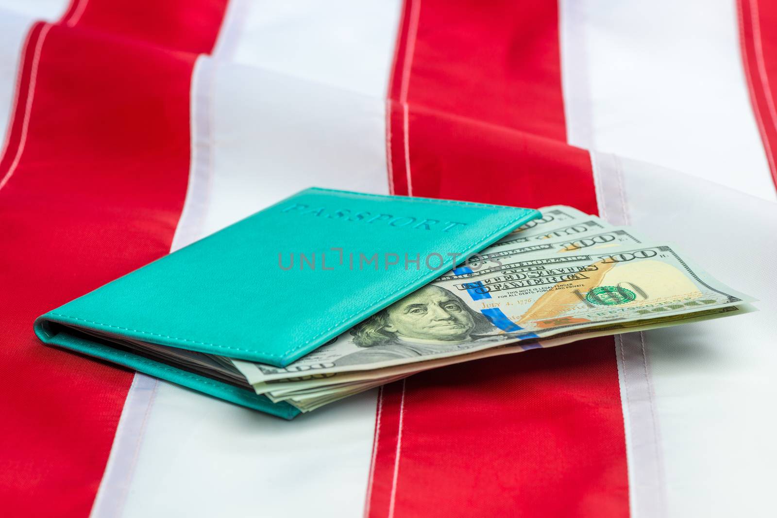 Passport stuffed with US dollars on a US flag close-up by kosmsos111