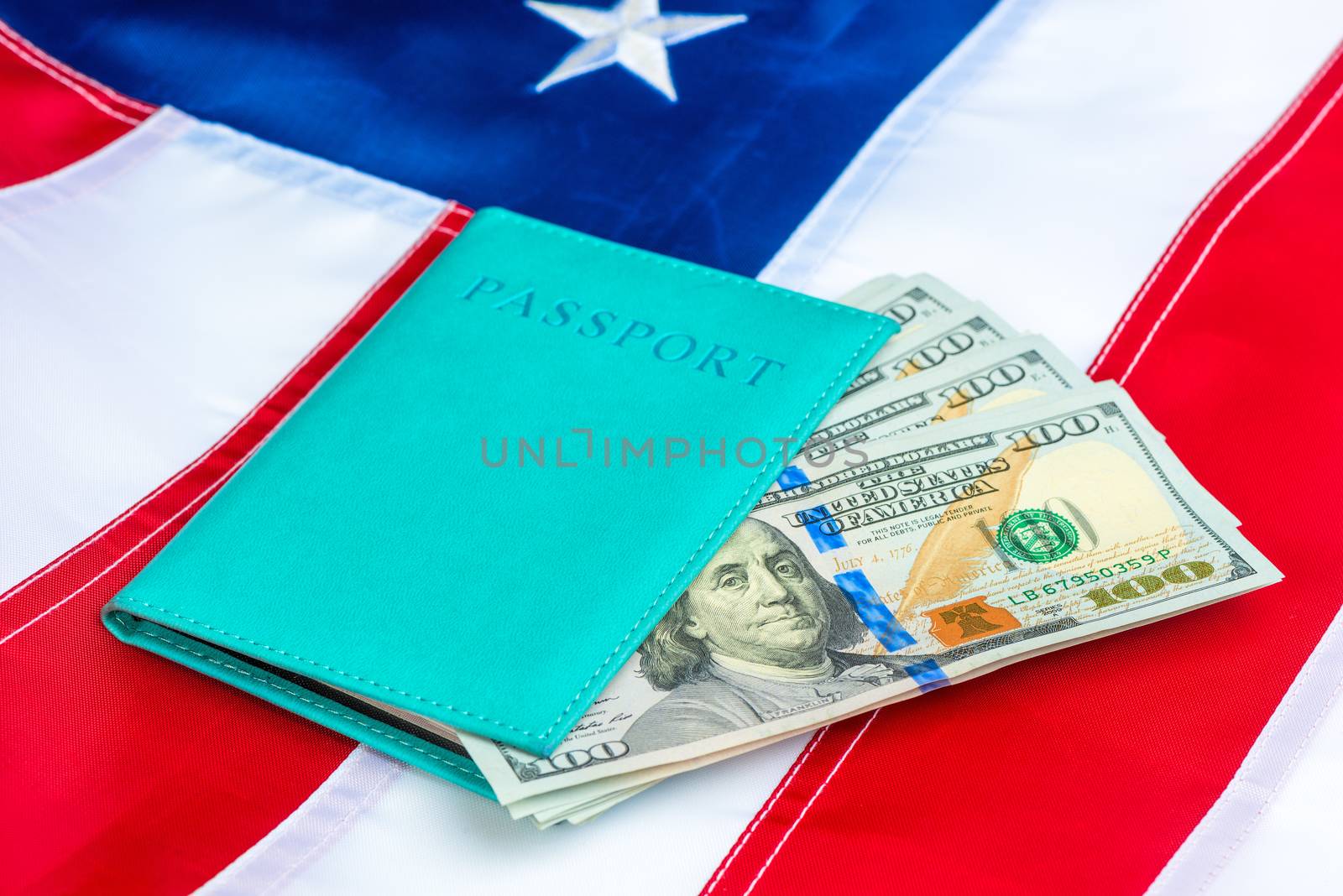 US flag close-up passport stuffed with US dollars