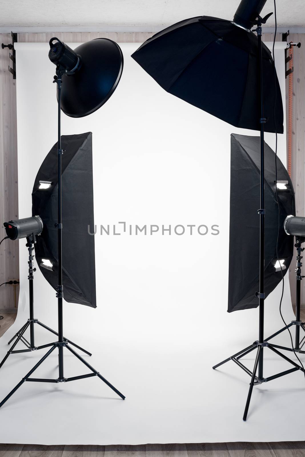 Photo studio equipment and white paper background indoors, no pe by kosmsos111