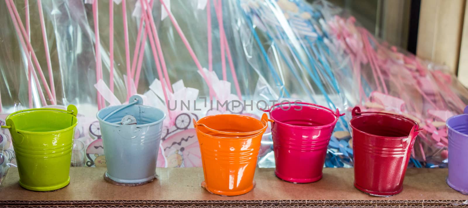 Little set of buckets of various colors in a market place