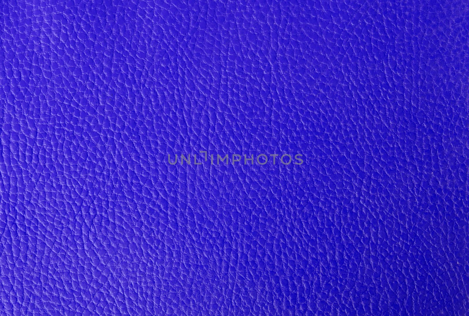 Bright blue leather background, part of an old binder folder