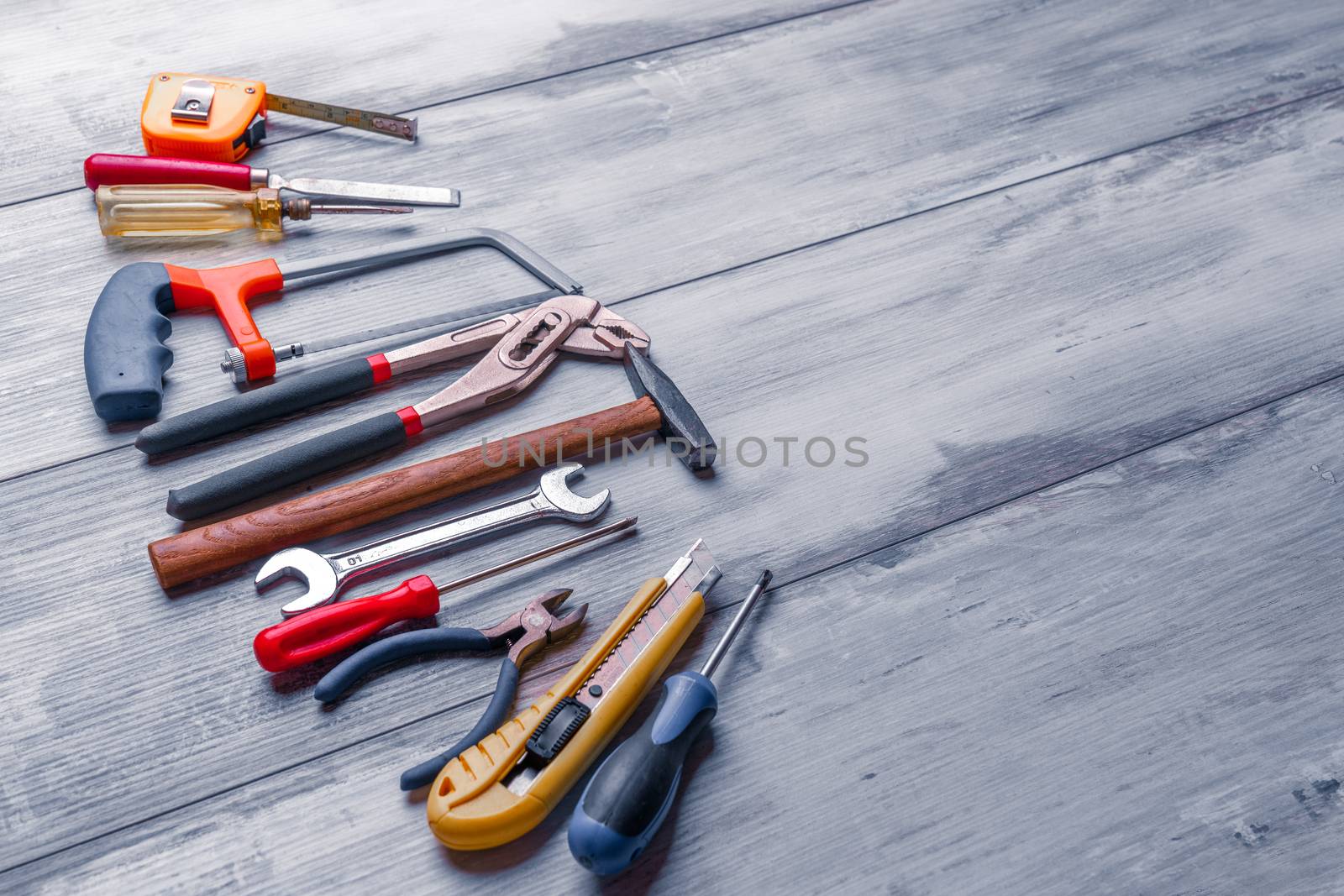 Screwdriver,hammer,tape measure and other tool for construction tools on gray wooden background with copy space,industry engineer tool concept.still-life.