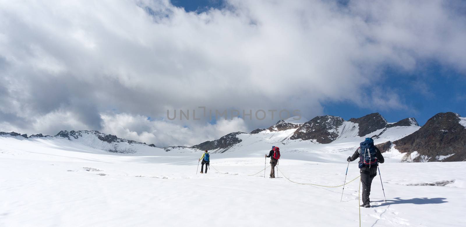 Hiking to mountain summit on snow glacier extreme trek