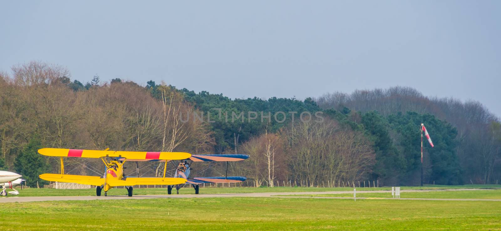 two stunting airplanes taking off on the airport, acrobatic flying and extreme sports by charlottebleijenberg