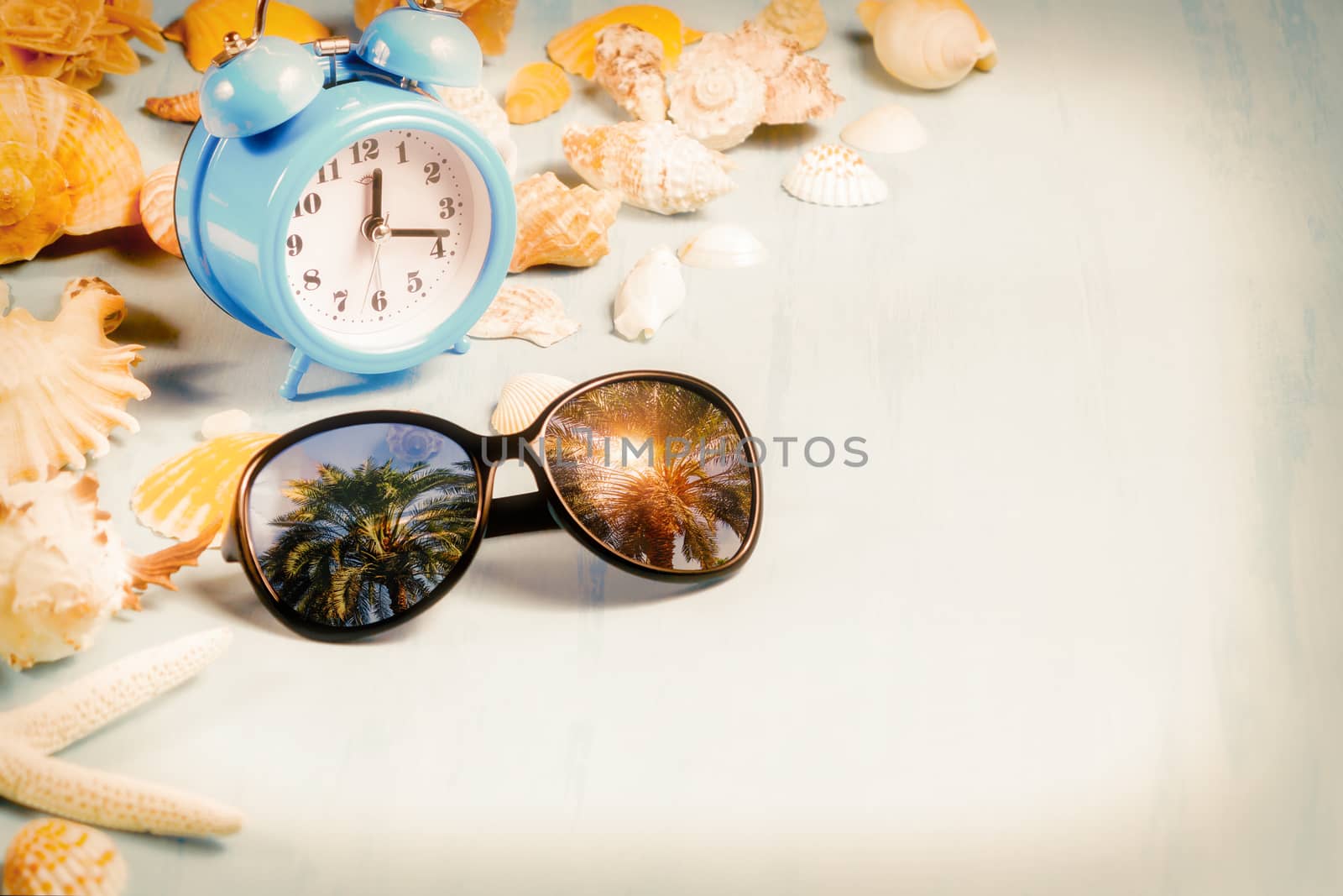 background with alarm clocks, sunglasses and seashells, summer holiday and vacation time concept by galsand