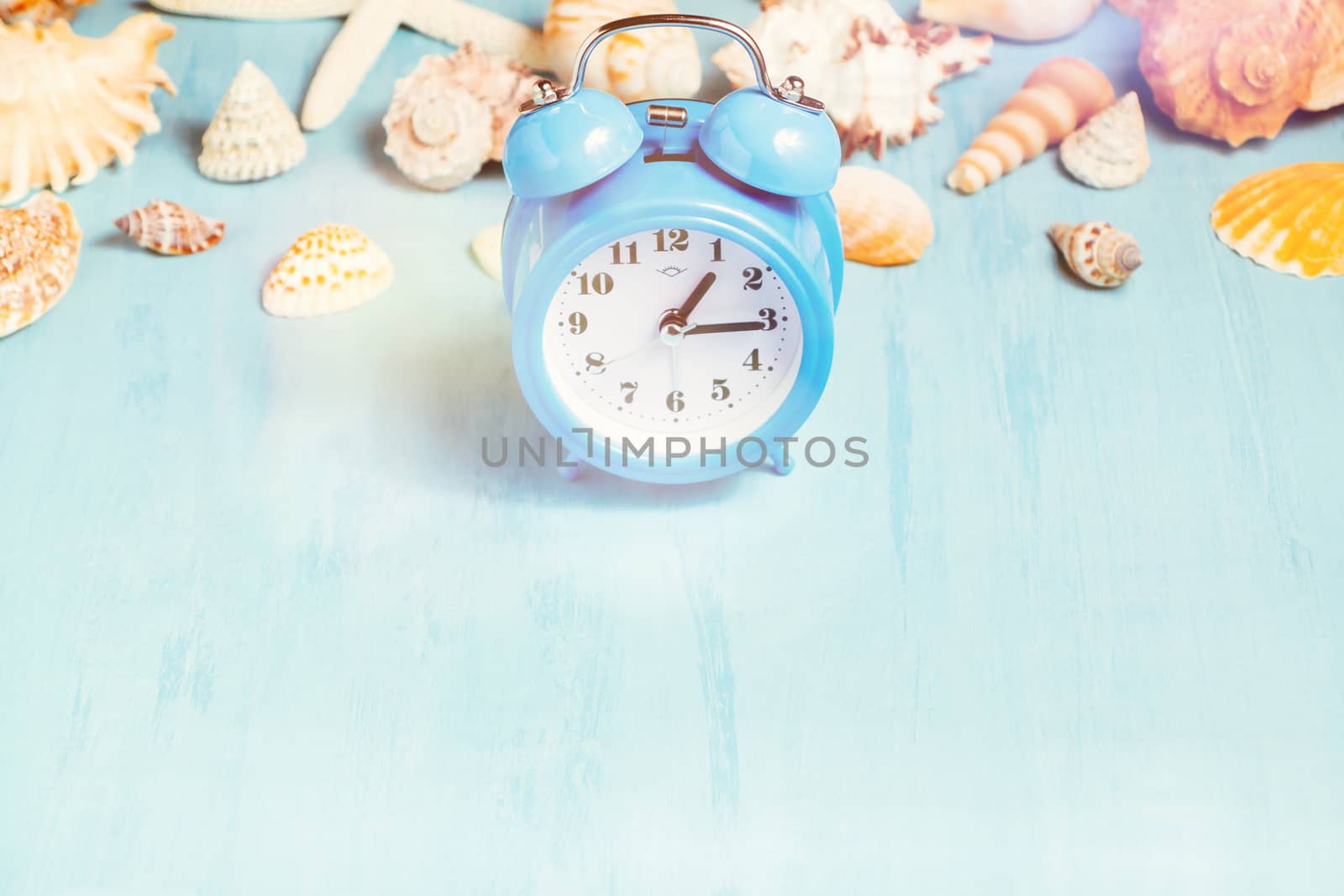 Blue sea background with alarm clocks and seashells, summer holiday and vacation time concept by galsand