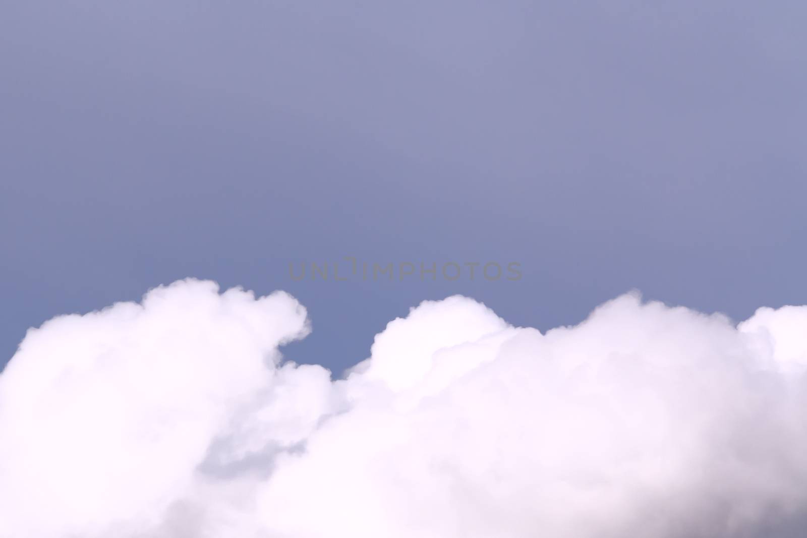 Lush cumulus clouds wide band in the summer blue sky. Background with copy space by galsand