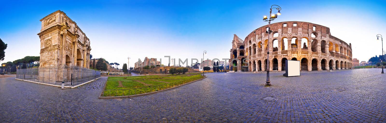 Colosseum and Arch of Constantine square panoramic dawn view in Rome, famous landmarks of capital of Italy