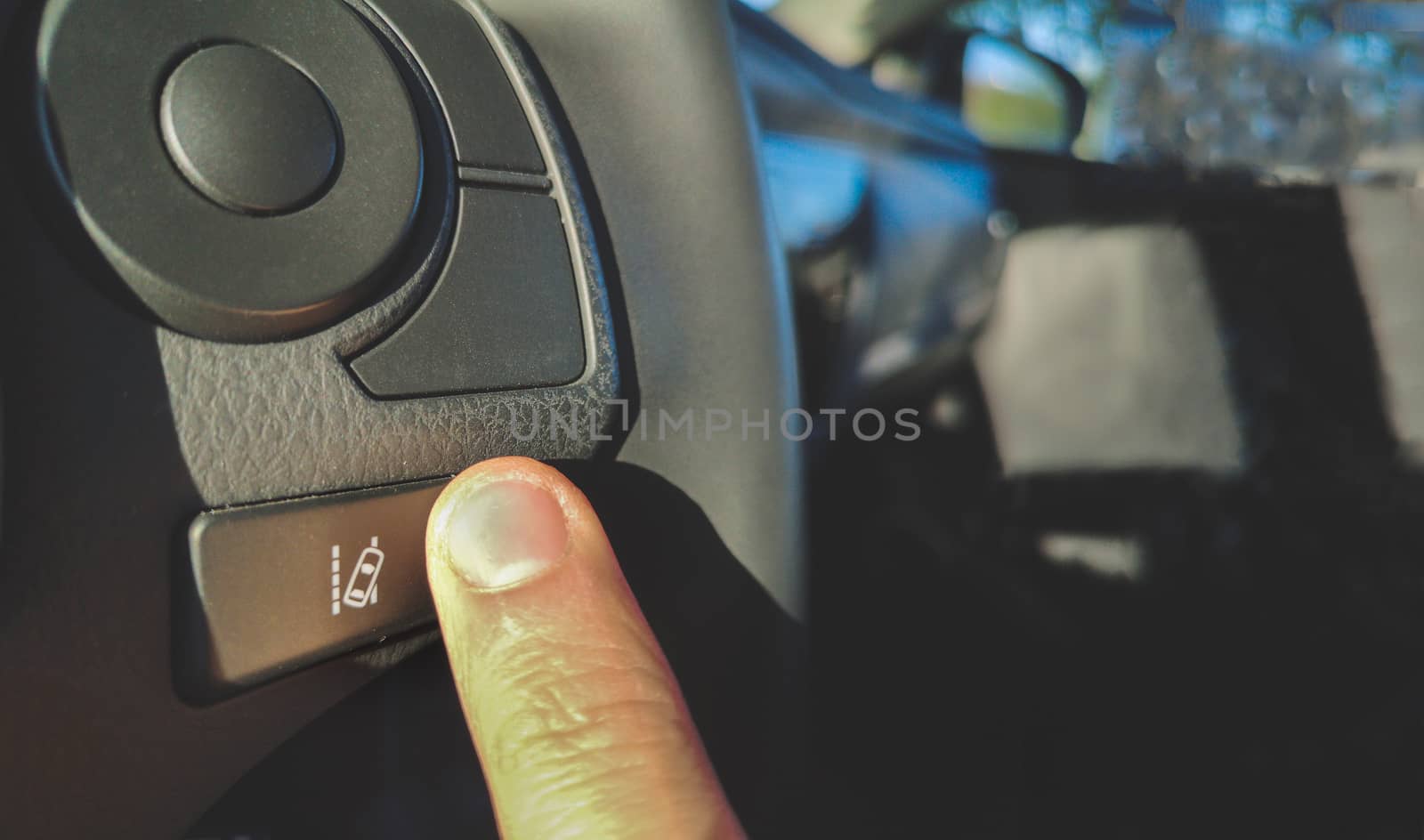 lane change assist system  button on the steering wheel of car by LucaLorenzelli