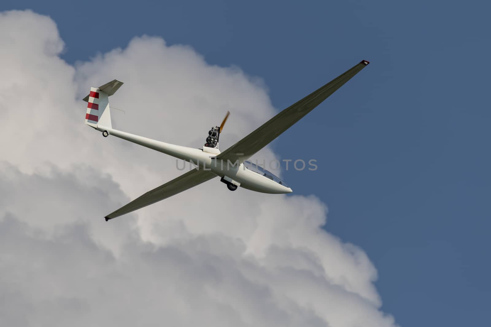 Motorized glider in a blue cloudy sky
 by Tofotografie