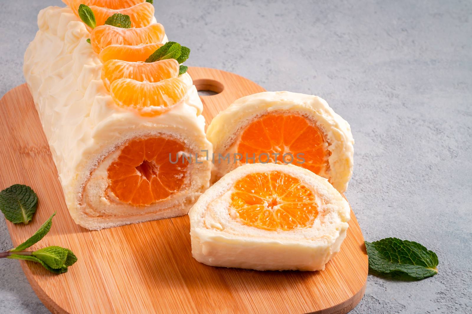 Sweet cake roll with whipped cream and tangerine filling.