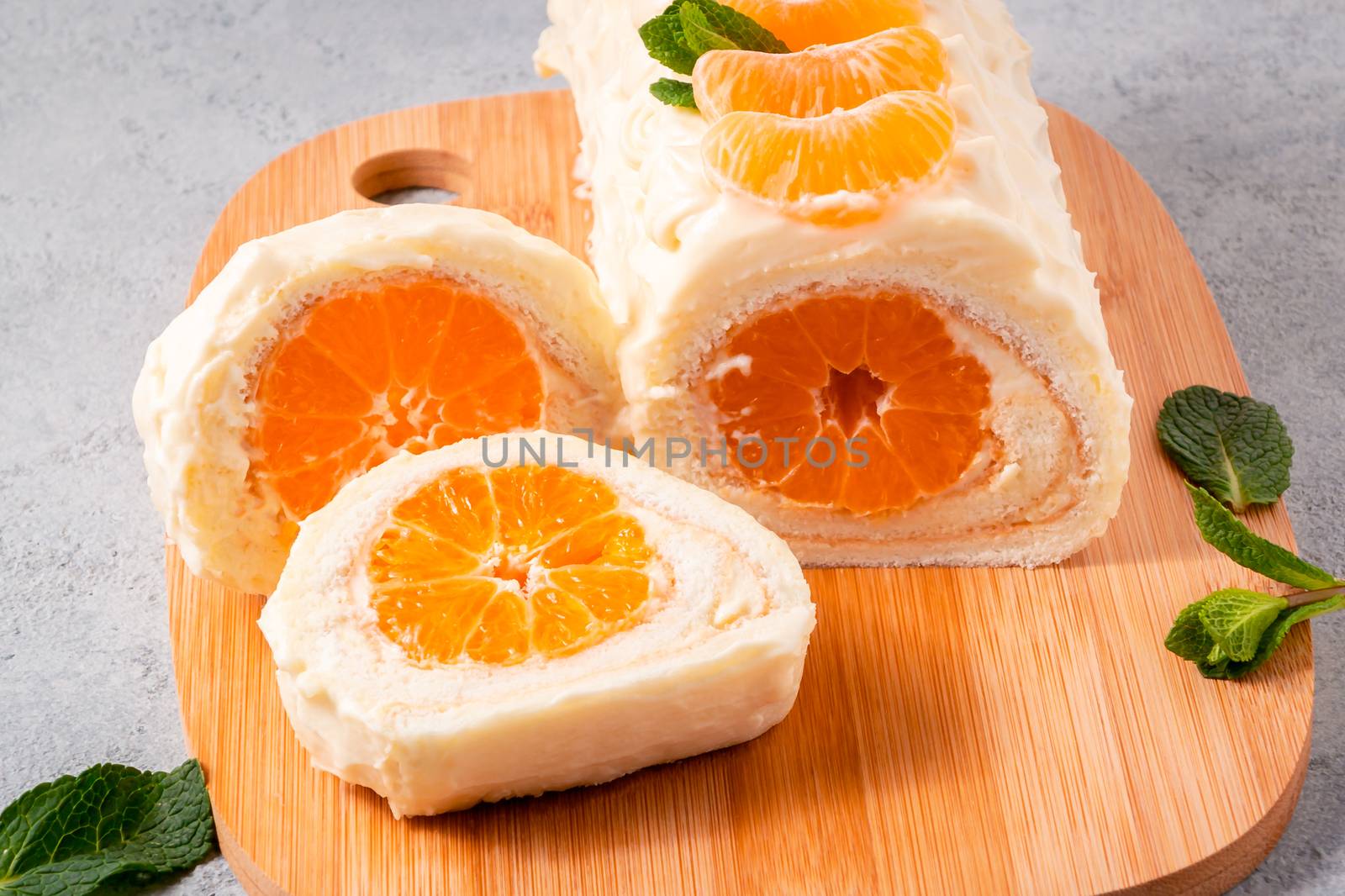 Sweet cake roll with whipped cream and tangerine filling by galsand