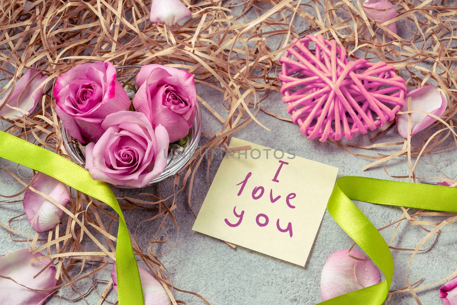 pink roses, a heart and a note with the inscription I love you on the table-the concept of love and care by galsand