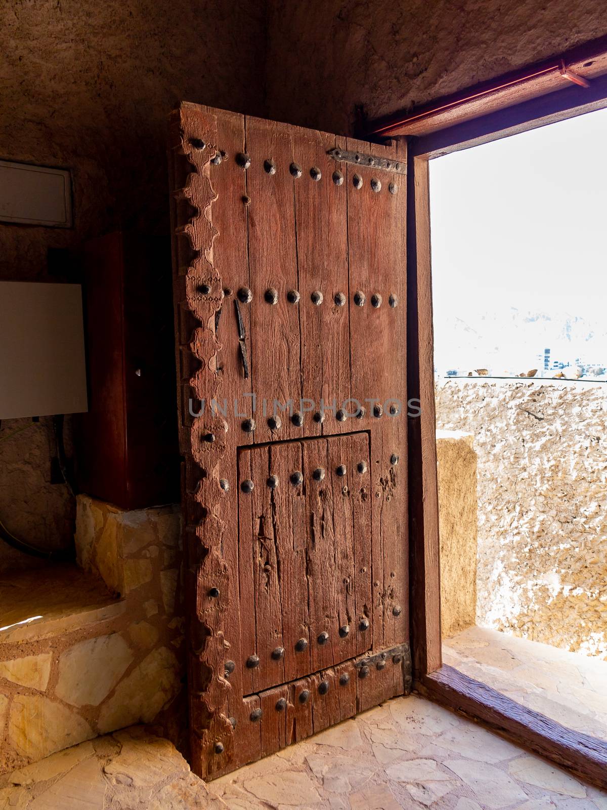 Massive antique door in Fort Muttrah in Muscat, the capital of Oman.