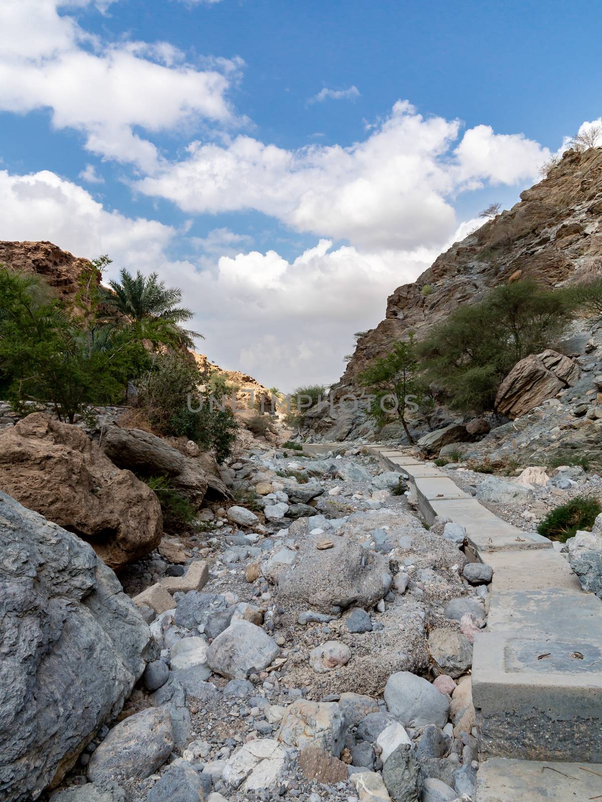 Parched riverbed called wadi in Asia, in the outskirts of Muscat, Oman by galsand
