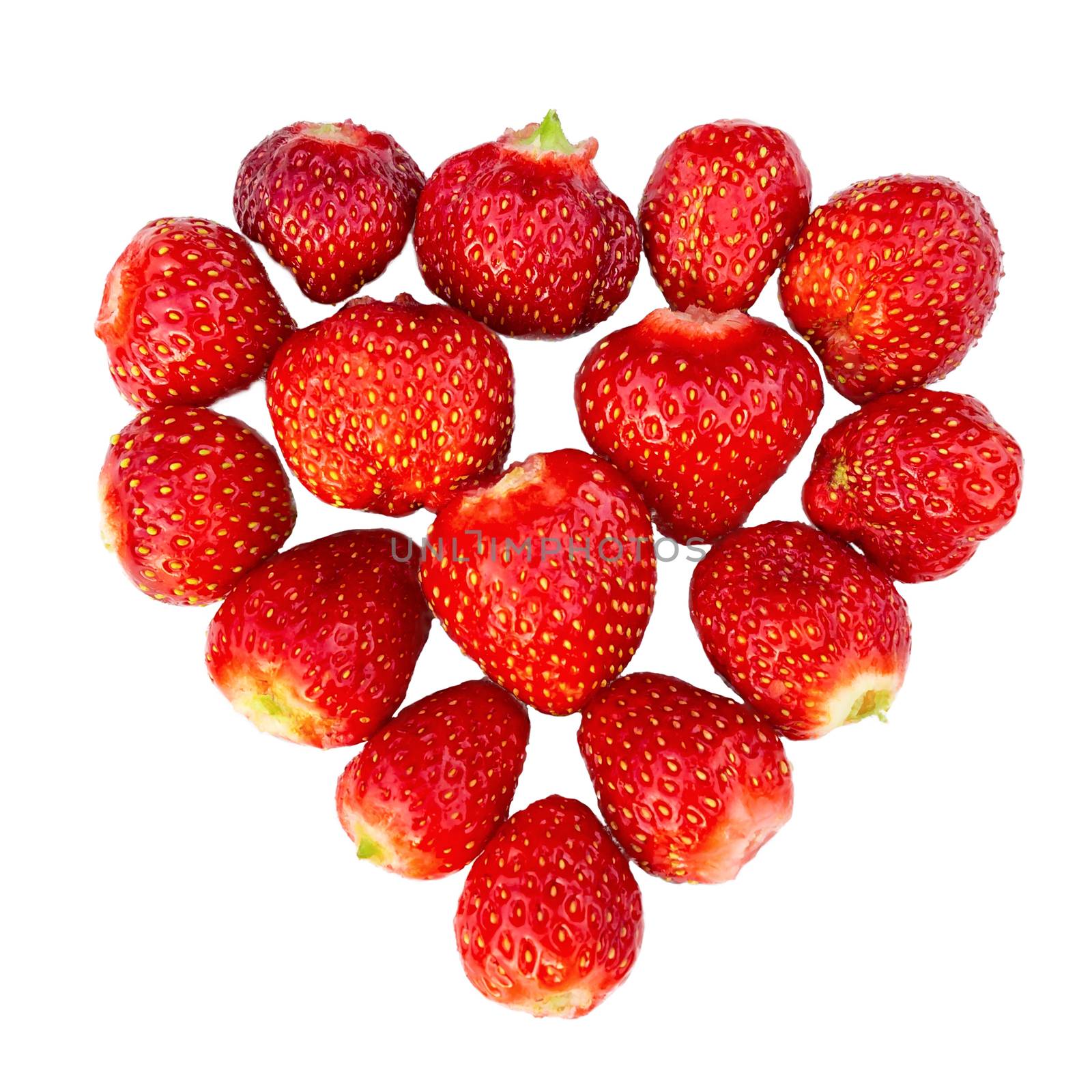 Fresh ripe strawberries laid out in the shape of a heart - love concept for design, isolated on white background.