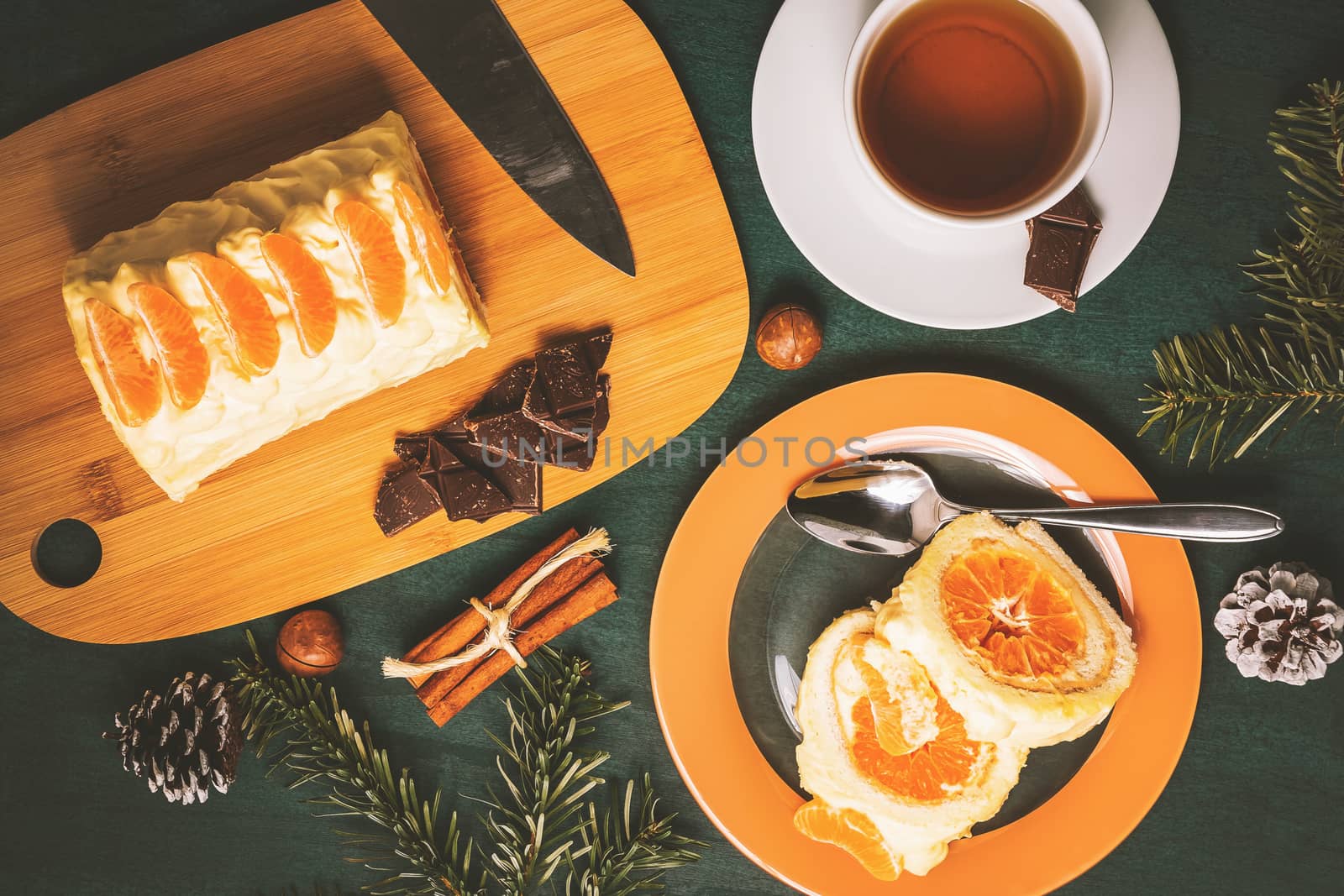 Sweet roll with whipped cream and tangerine filling and Christmas decorations by galsand