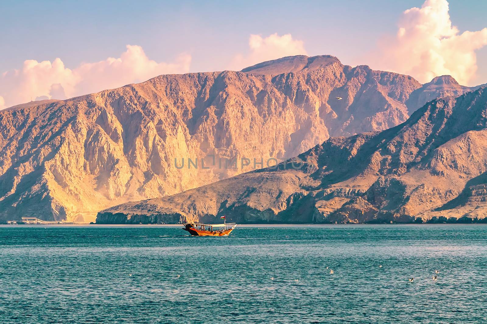 Sea, pleasure boats, rocky shores in the fjords of the Gulf of Oman by galsand