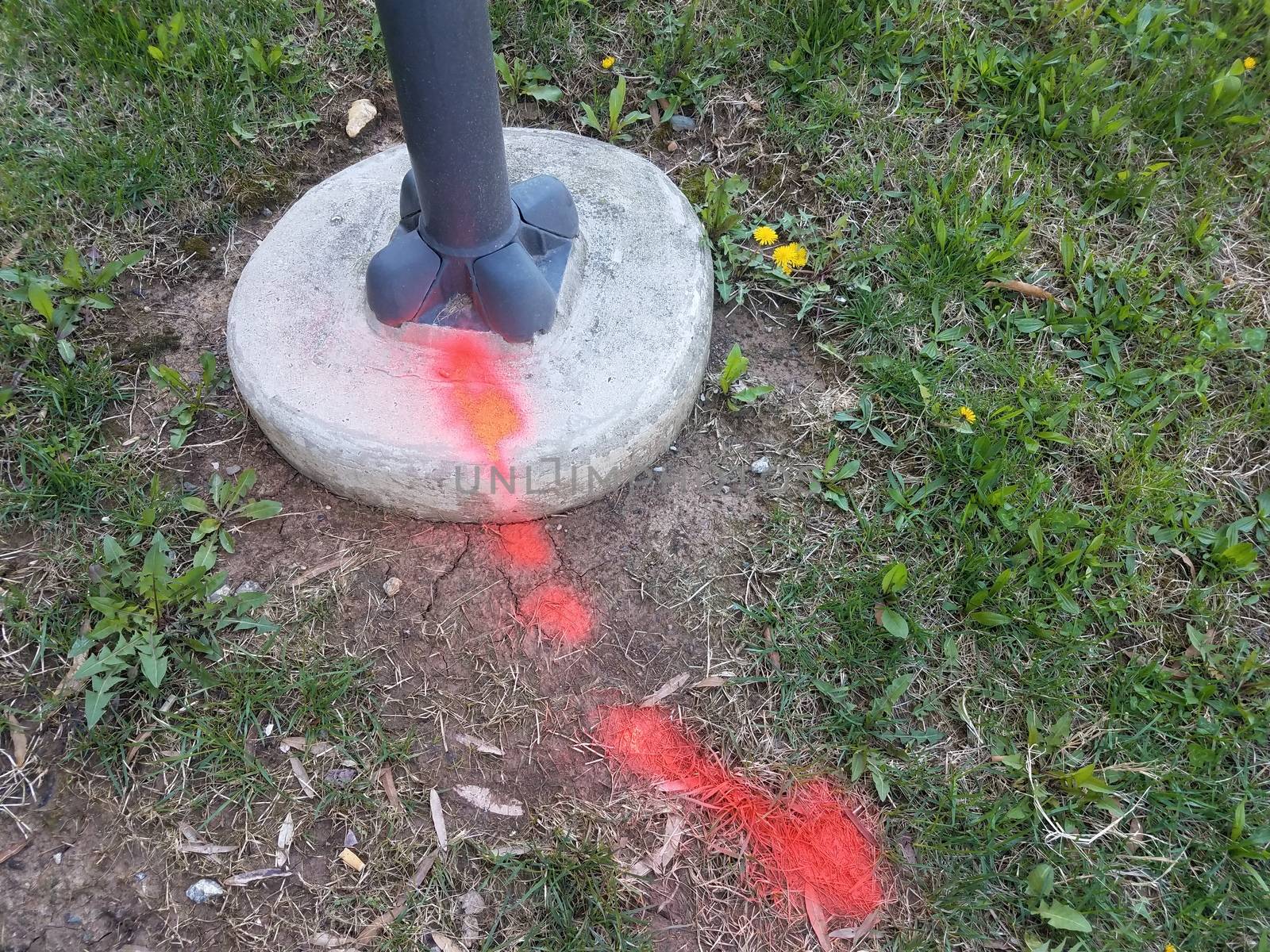 red paint on grass or ground and street light by stockphotofan1