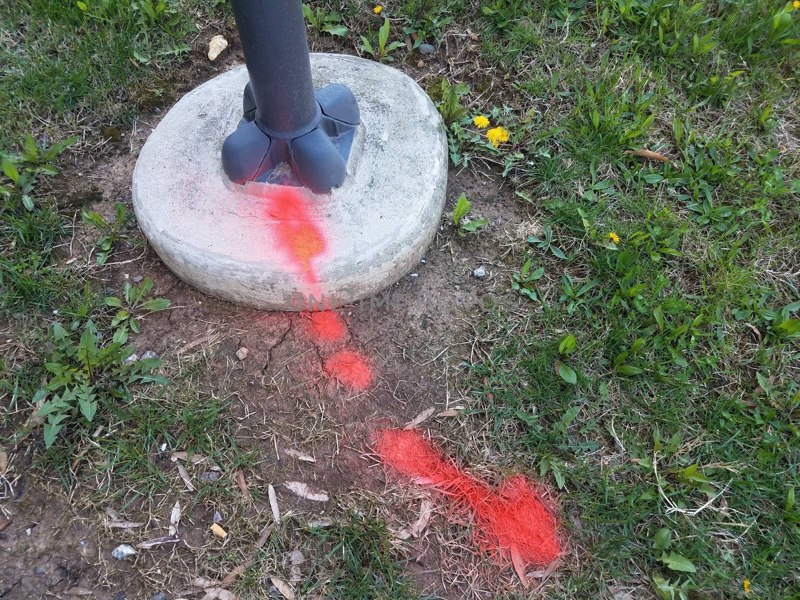 red paint on grass or ground and street light by stockphotofan1