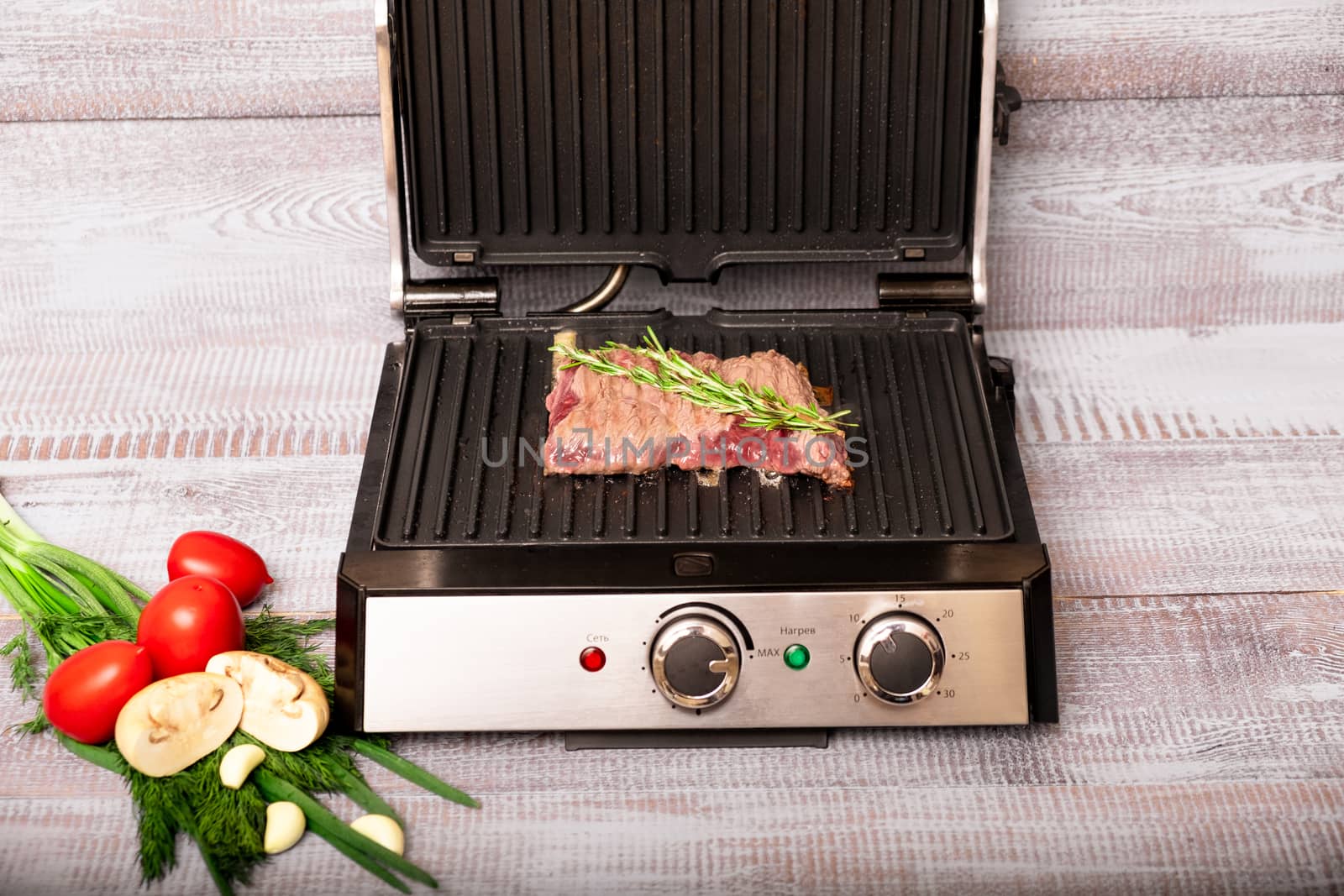 Beef steak with vegetables. Preparation on electric grill by rdv27