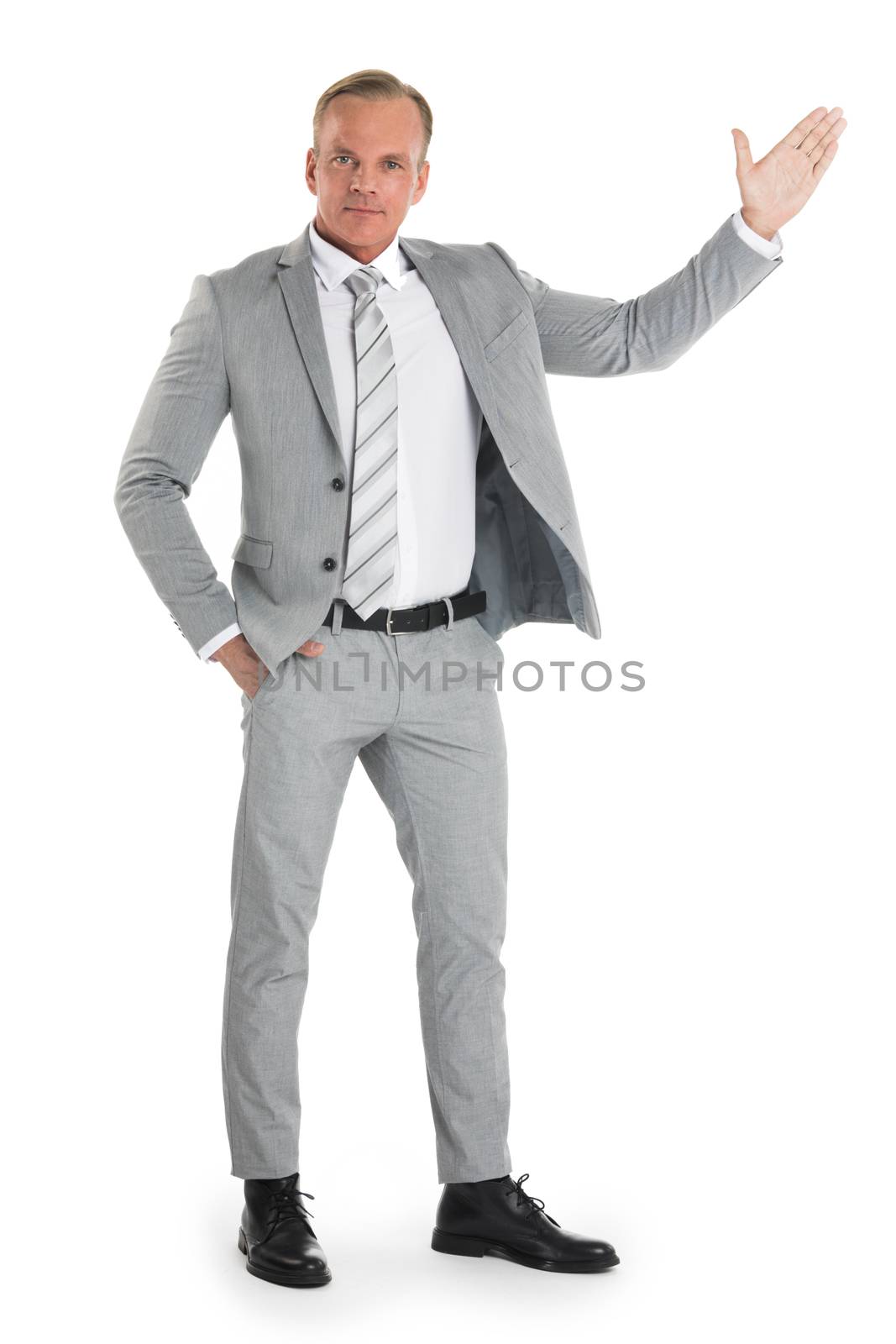 Businessman pointing with hand palm at empty copy space, studio isolated on white background, full length portrait