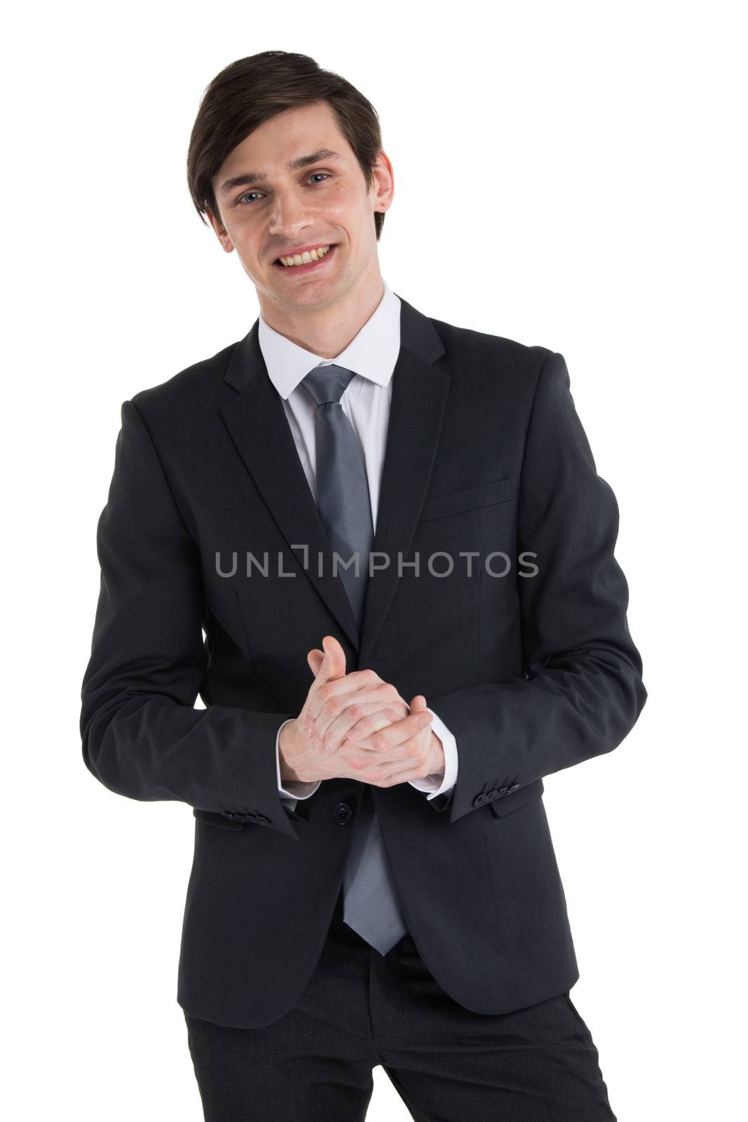 Young smiling business man rubbing his hands , studio isolated on white background