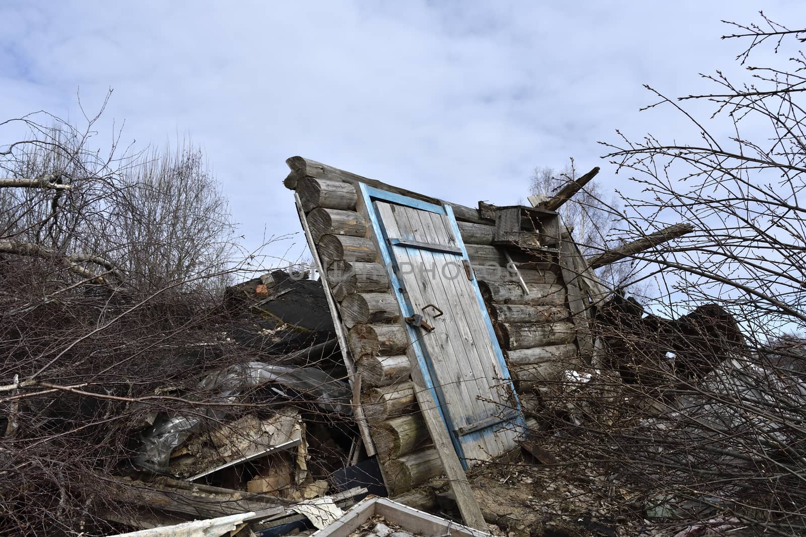 destroyed village house, remained part of the wall with a door