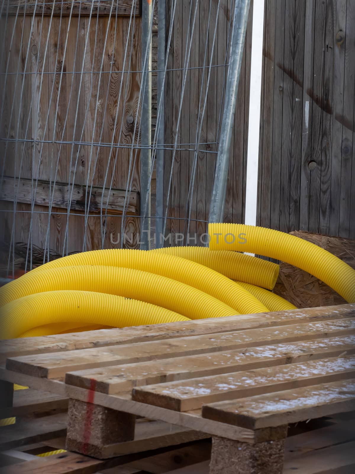 Hose, pallet and grid on a construction site by sandra_fotodesign