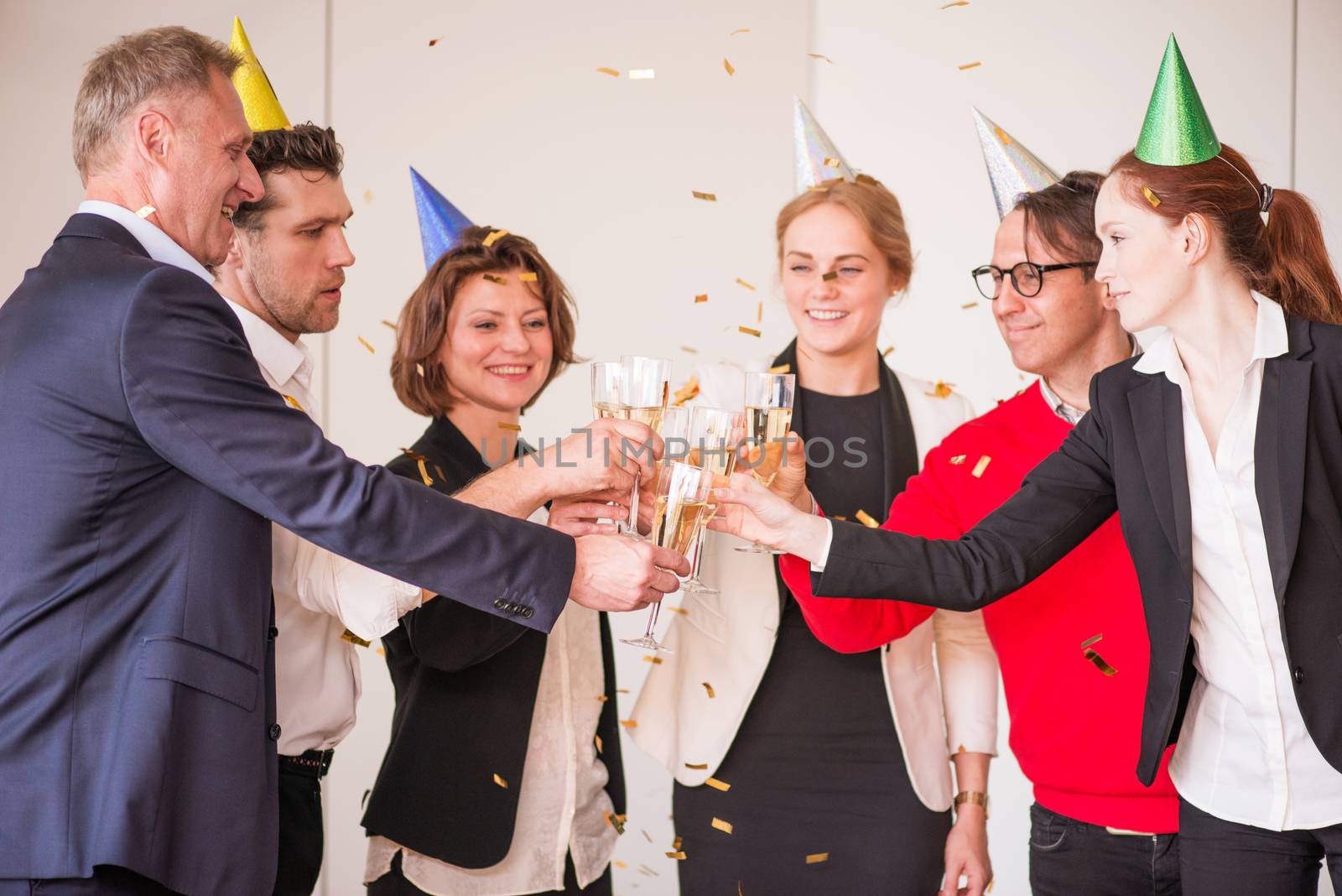 Business people at office party clinking glasses