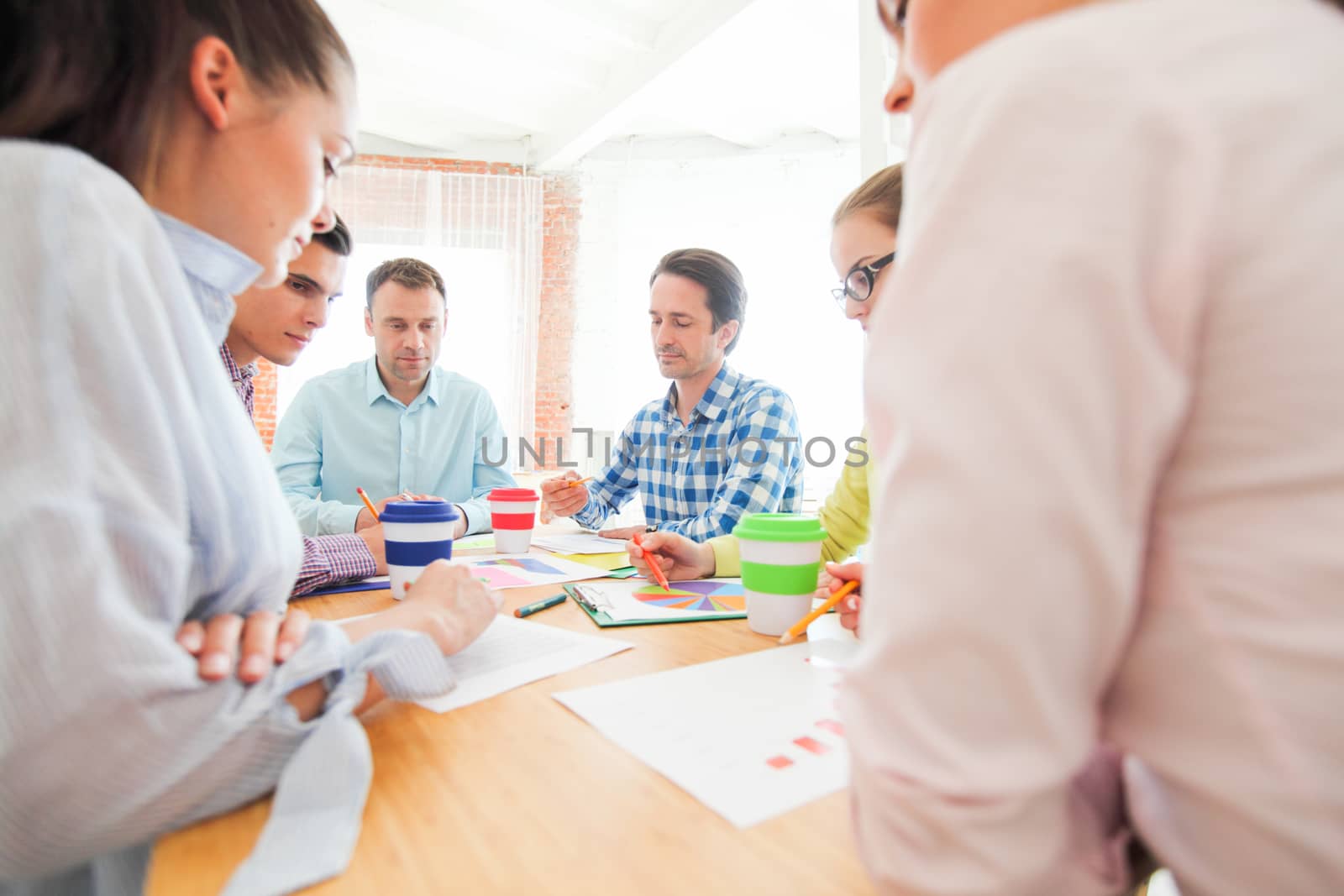 Group of business people busy discussing financial matter during meeting