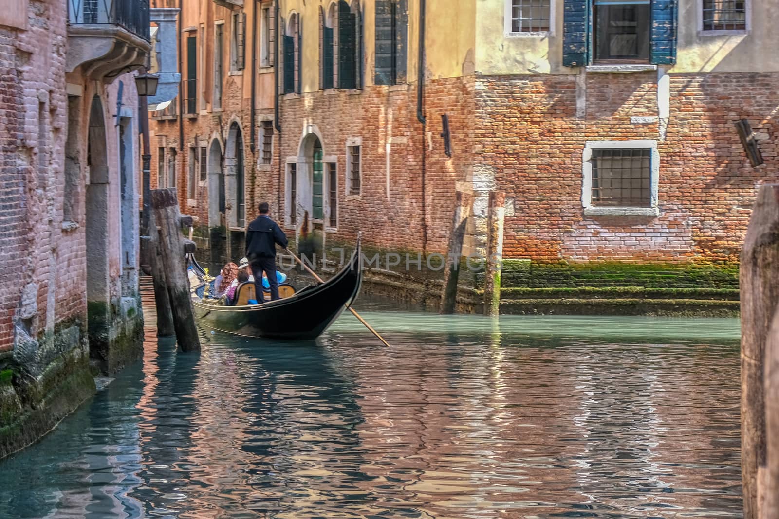 Romantic gondola ride in the canals of Venice, Italy, people unrecognizable